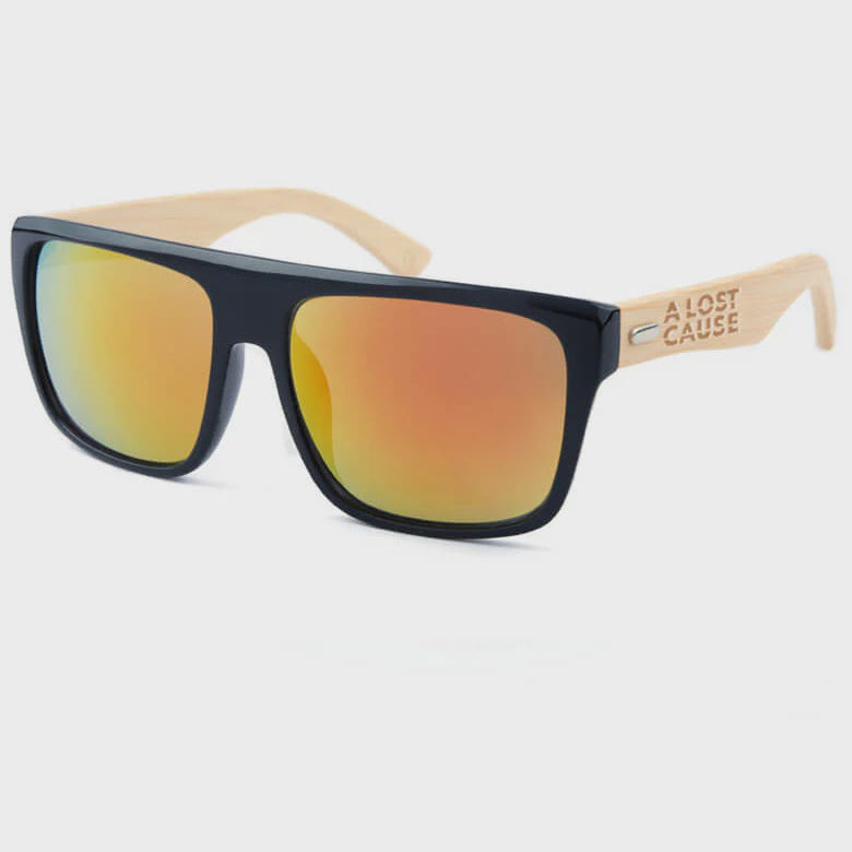Sunglasses with black frame and orange-tinted lenses on a white background