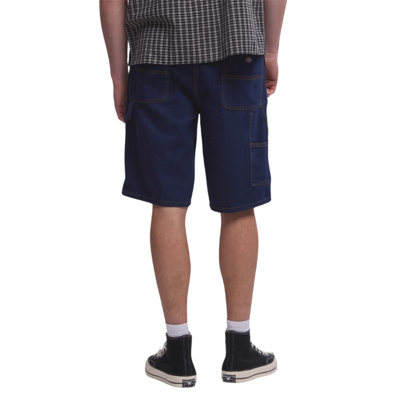 Person wearing blue denim shorts on a white background