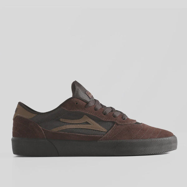 Brown sneaker with black sole on a light gray background