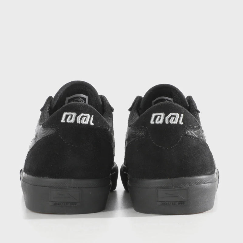 Black sneakers with a brand logo on a white background