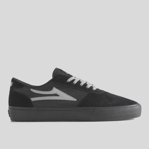 Black sneaker with a gray logo on a light gray background