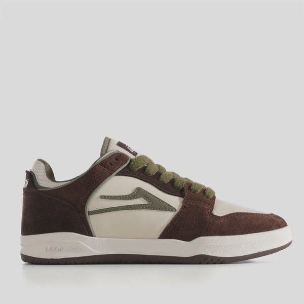 Brown and white sneaker with green accents on a light gray background