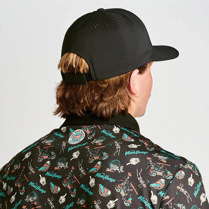 Person wearing a black cap and a patterned shirt with various designs.