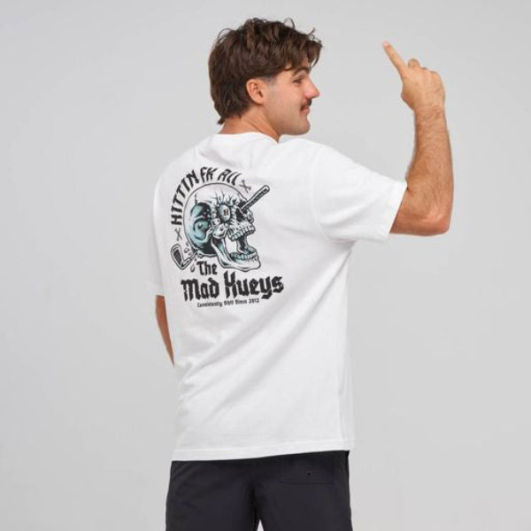A man wearing a white t-shirt with a large black and blue graphic on the back, paired with black shorts, socks, and sneakers, standing against a light gray studio background.