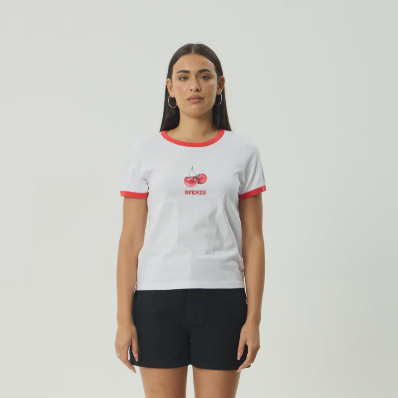 Person wearing a white t-shirt with red accents and black shorts on a light gray background