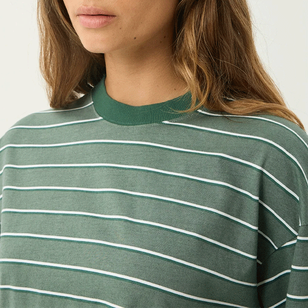 a women wearing a green t-shirt with white strips 