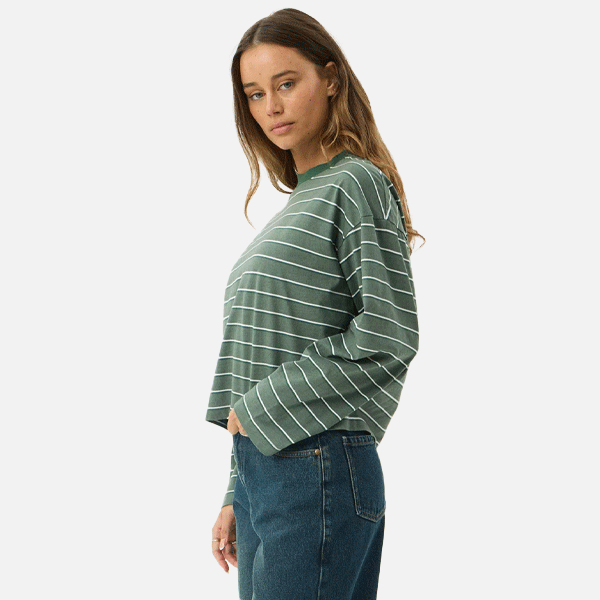 a women wearing a green t-shirt with white strips 