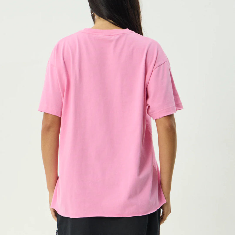 Person wearing a pink oversized t-shirt on a plain background