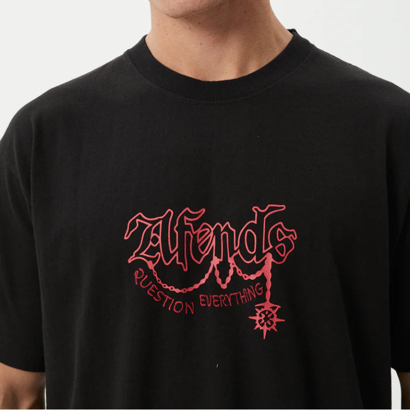 Man wearing a black t-shirt with red text on a white background