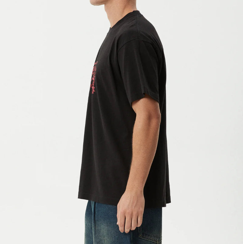 Person wearing a black t-shirt with a small graphic on a white background