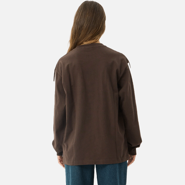 a women wearing a brown shirt with a white logo and white strips 