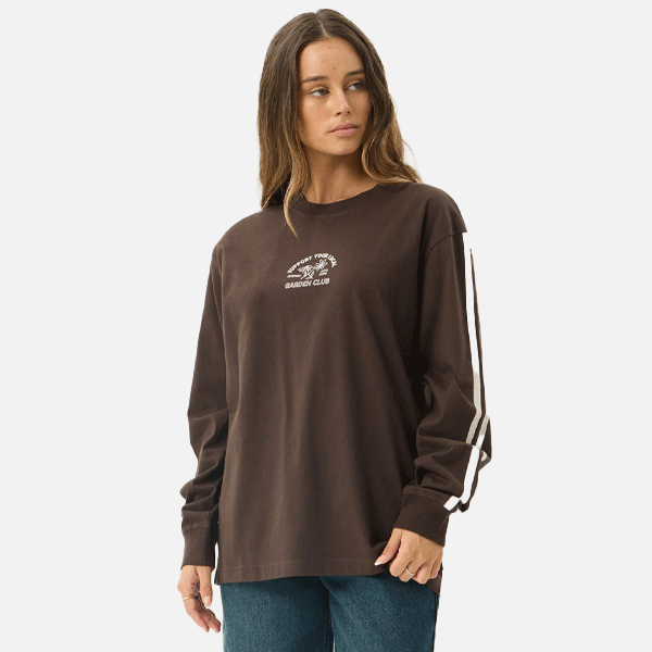 a women wearing a brown shirt with a white logo and white strips 