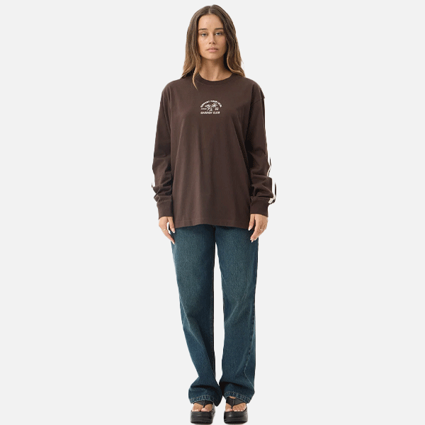 a women wearing a brown shirt with a white logo and white strips 
