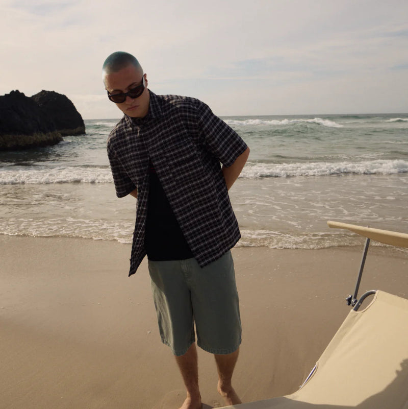 Man standing on the beach with ocean waves in the background