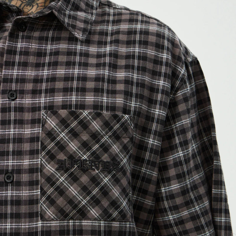 Plaid shirt with a pocket detail on a plain background