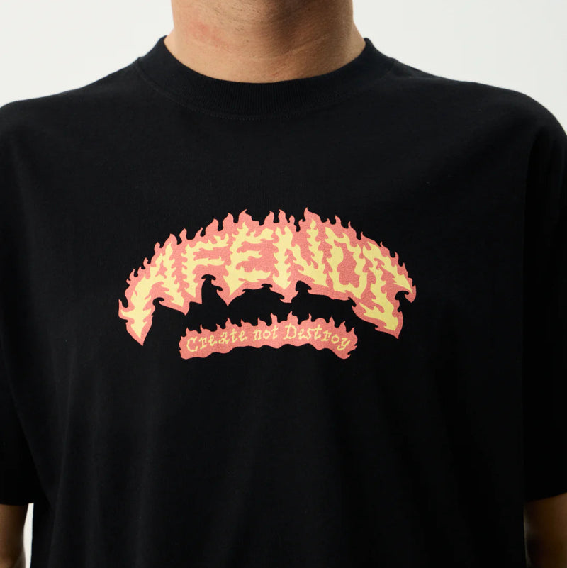 Person wearing a black t-shirt with a yellow and red graphic design on a white background