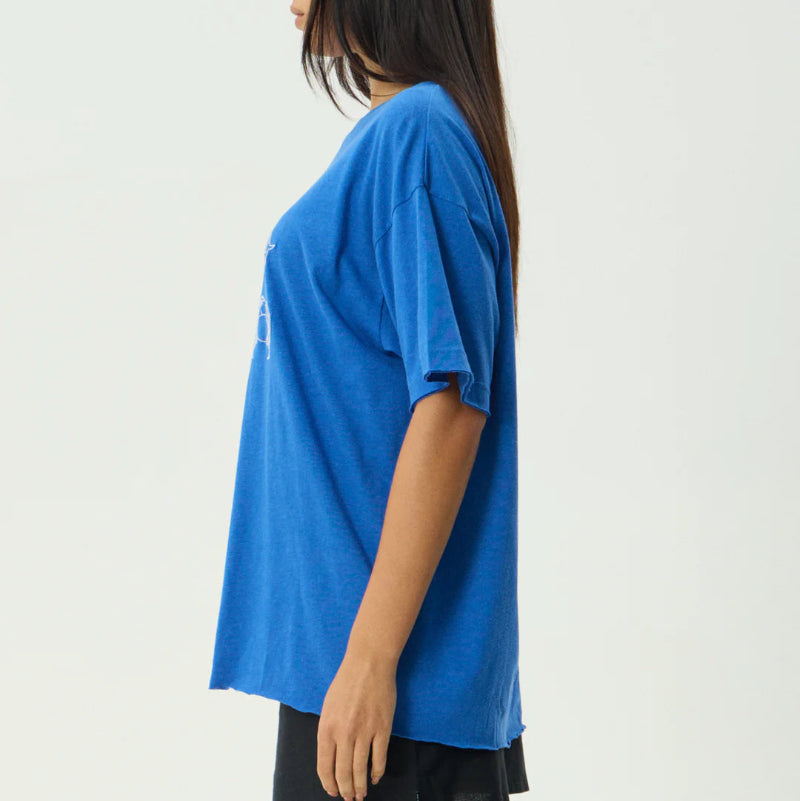 Woman wearing a blue oversized t-shirt on a white background