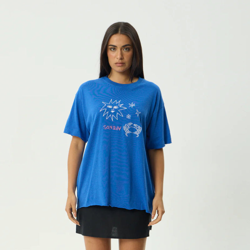 Woman wearing a blue t-shirt with a graphic design on a white background