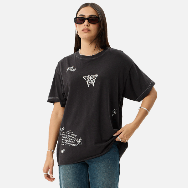 a women wearing a black t-shirt with a white logo also wearing sun glasses