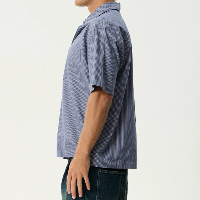 Man wearing a blue striped shirt against a white background