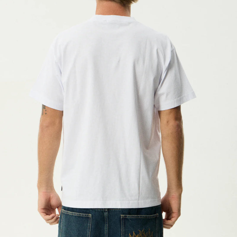 Person wearing a plain white t-shirt with a visible brand logo on jeans.