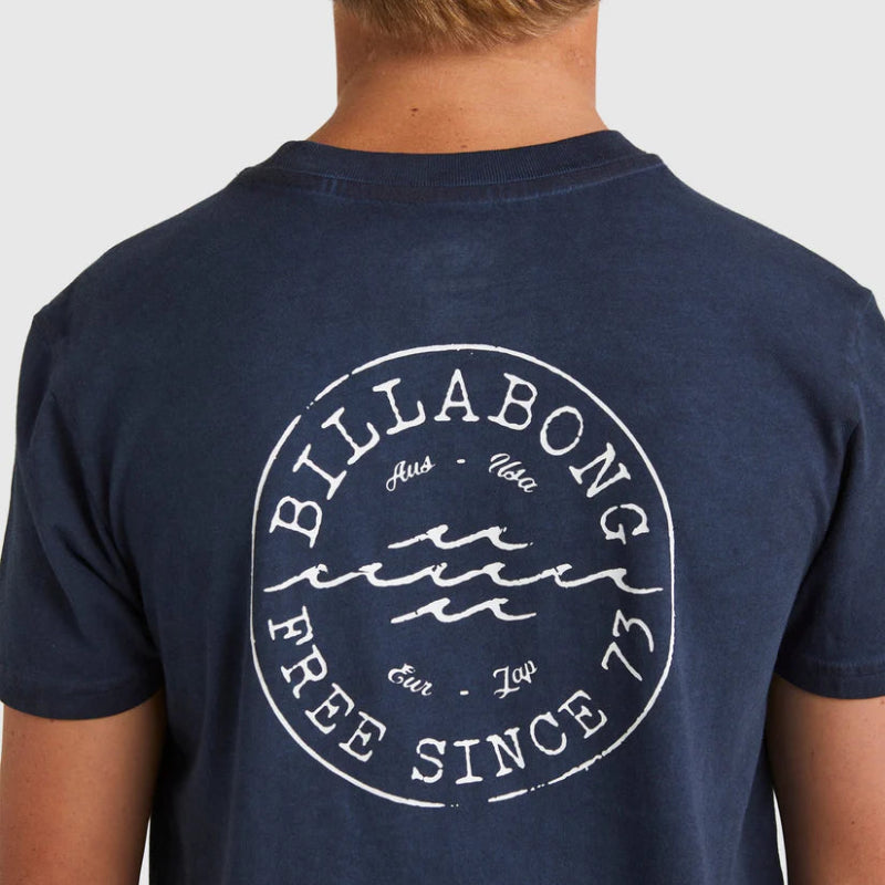 Navy blue t-shirt with Billabong logo on the back, worn by a person.