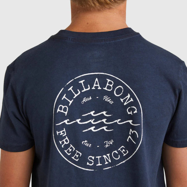 Navy blue t-shirt with Billabong logo on the back, worn by a person.