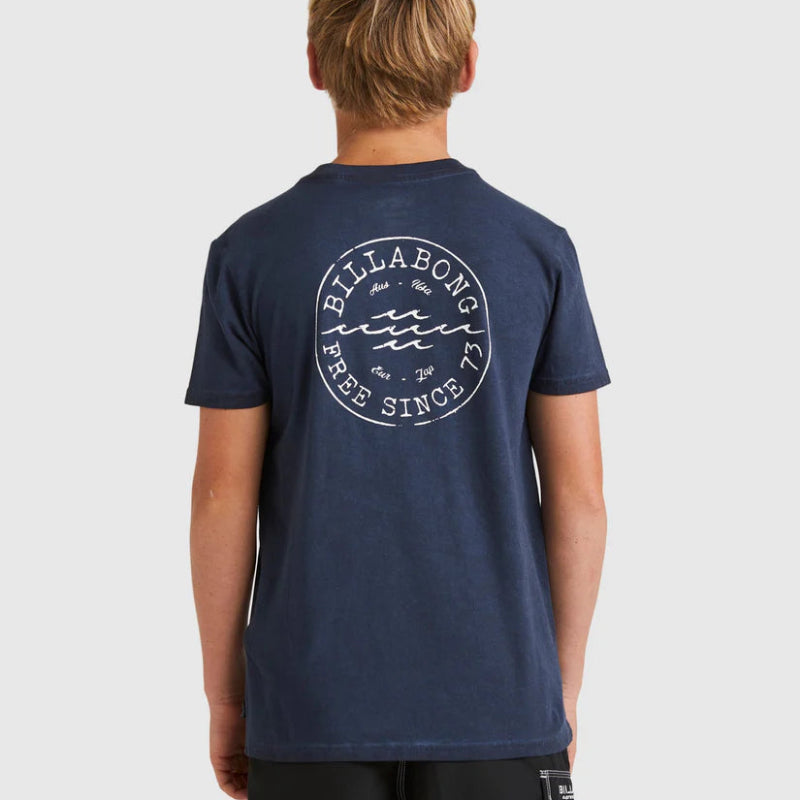 Person wearing a navy Billabong t-shirt with branding on the back against a white background