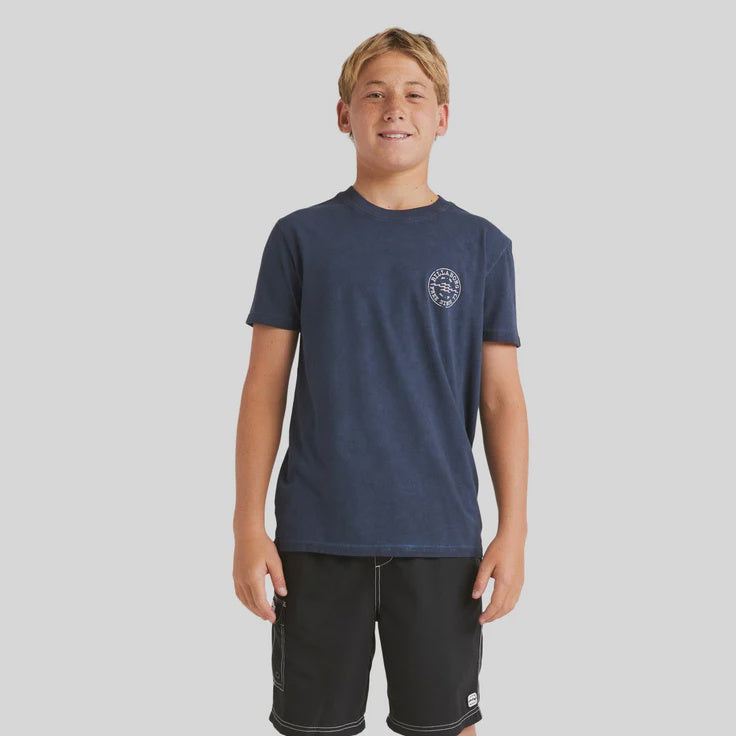 Young boy wearing a navy t-shirt and black shorts on a white background