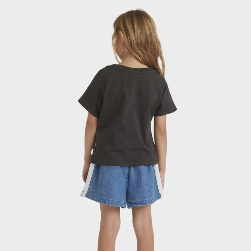 Child wearing a black t-shirt and blue denim shorts on a white background