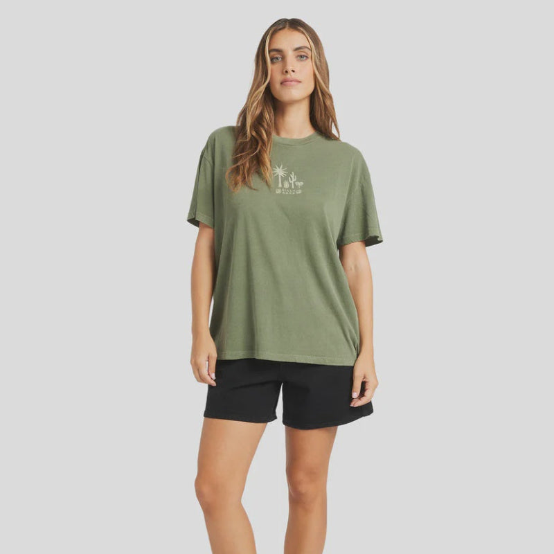 Woman wearing a green t-shirt and black shorts on a white background