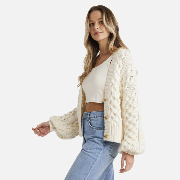 women wearing a white button up knitted billabong cardigan 
