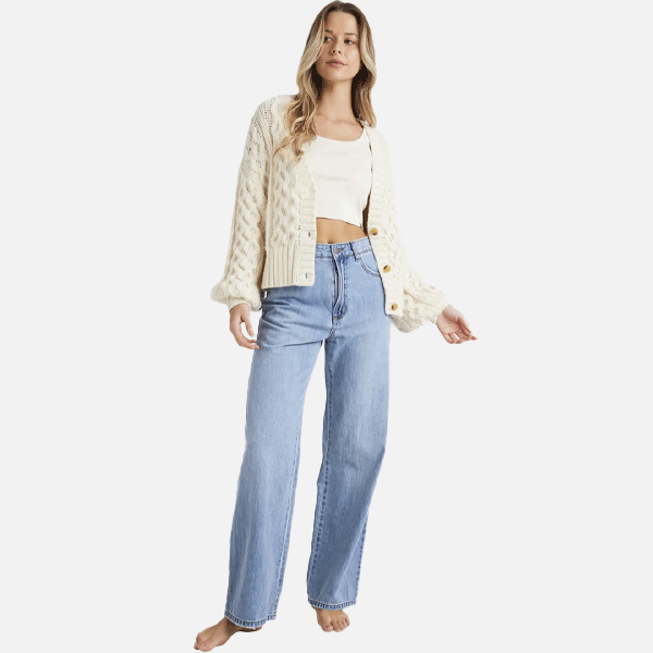 women wearing a white knitted billabong cardigan with blue jeans and a white singlet 