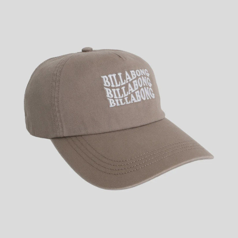 Brown cap with Billabong logo on a gray background
