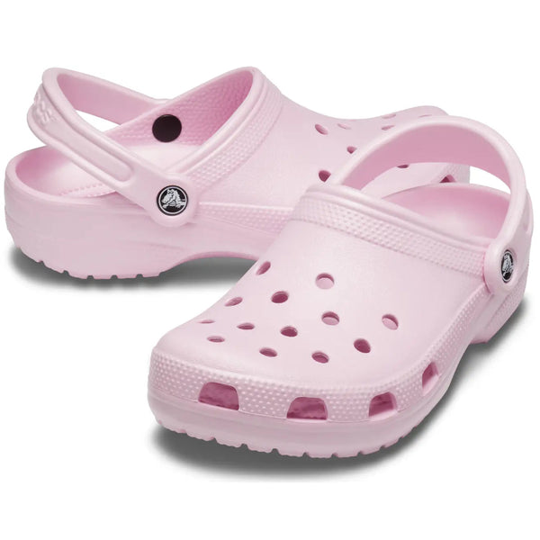 Pair of pink clogs on a white background