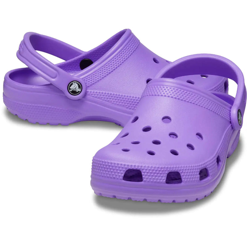 Pair of purple clogs on a white background