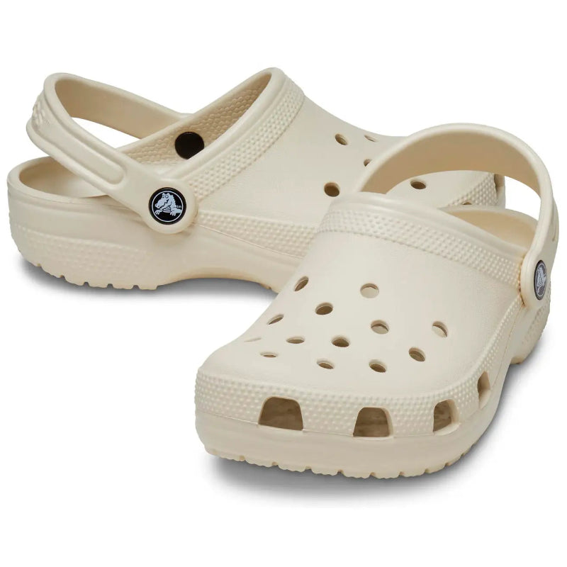 Beige clogs with a brand logo on a white background