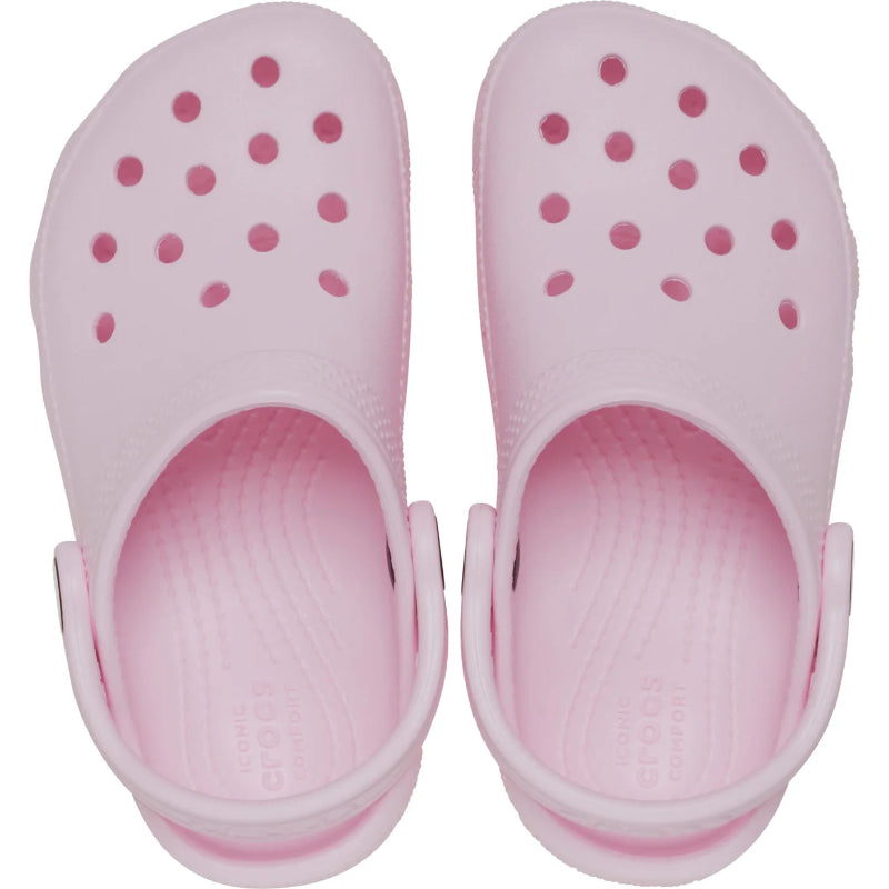 Pair of pink clogs with a white sole on a white background
