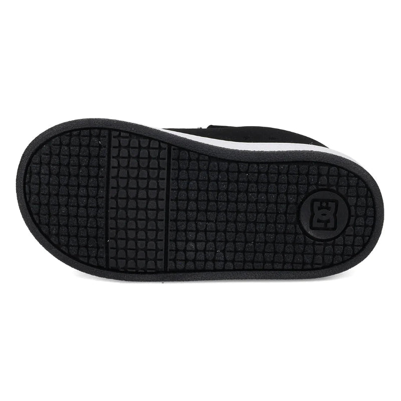 The black textured rubber outsole of a shoe, featuring a grid pattern and a circular logo embossed on the heel, shown against a plain white background.