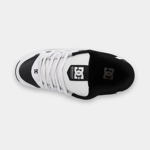 A DC Shoes low-top sneaker shown from a top-down view, featuring a white leather upper with black overlays, white laces, and a black heel counter on a light gray background.