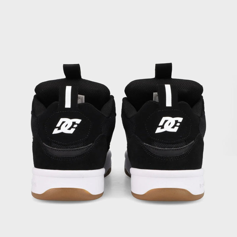 Black DC shoes with white soles on a light gray background