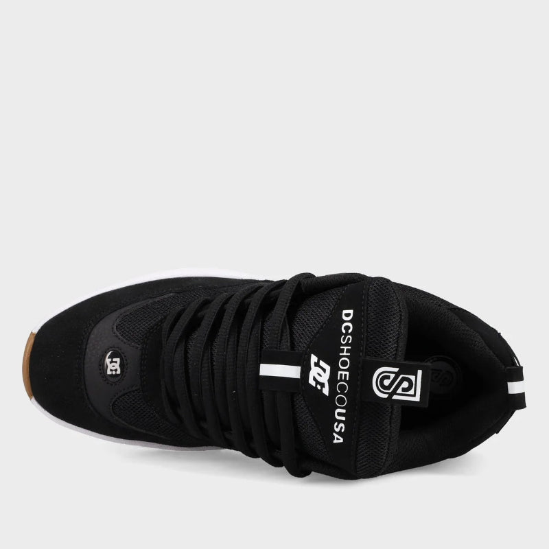 Black sneaker with visible branding on a light gray background