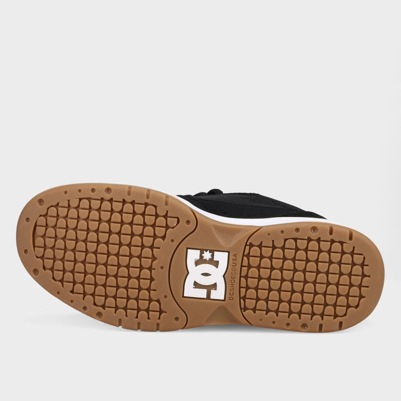 Close-up of a shoe sole with a brand logo on a light gray background