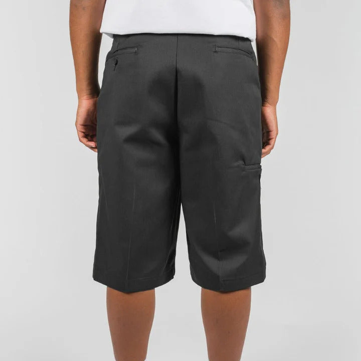 Person wearing black cargo shorts on a white background