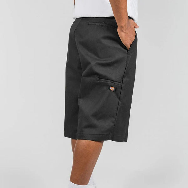 Person wearing black shorts on a white background