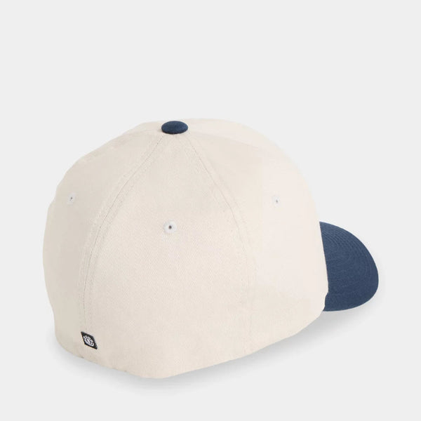 An off-white baseball cap with a navy blue visor and matching navy button on top, shown from a three-quarters angle against a light gray background.