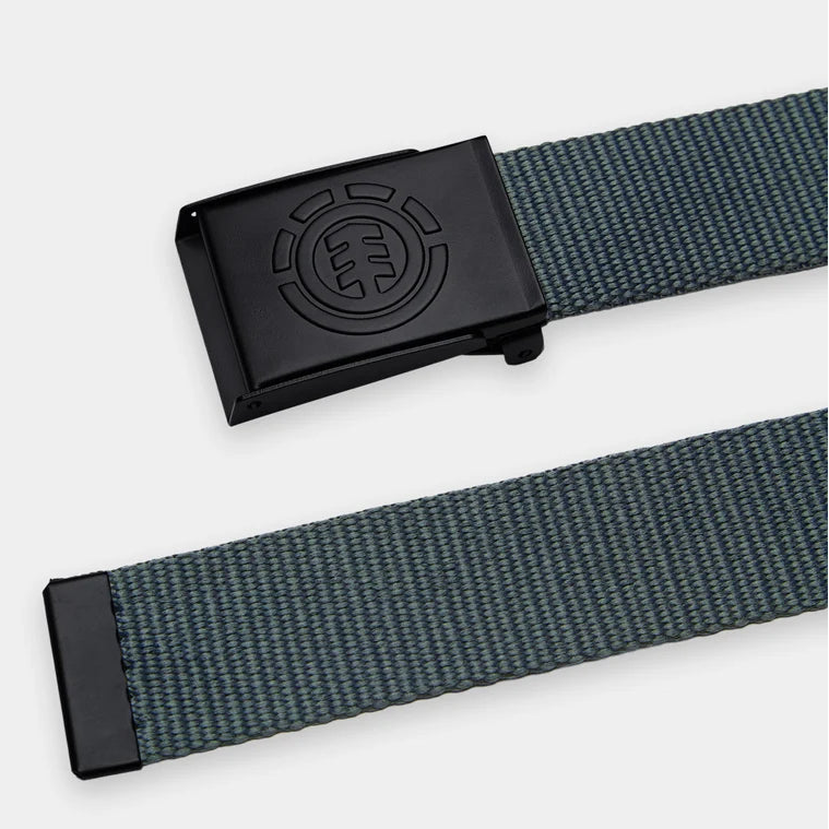 A close-up of a woven belt strap in dark gray and blue with a black metal buckle featuring an embossed circular logo, shown on a light gray background.