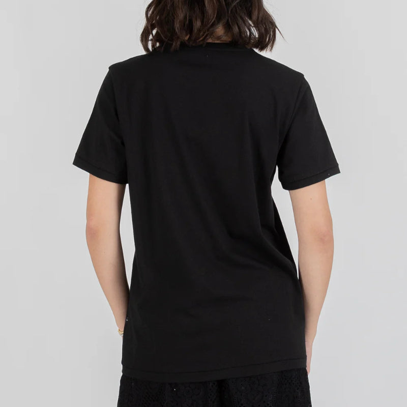 Person wearing a black t-shirt against a plain background