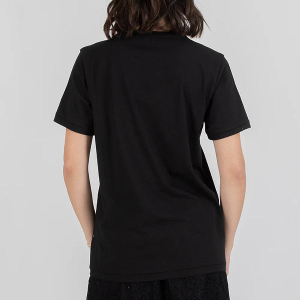 Person wearing a black t-shirt against a plain background