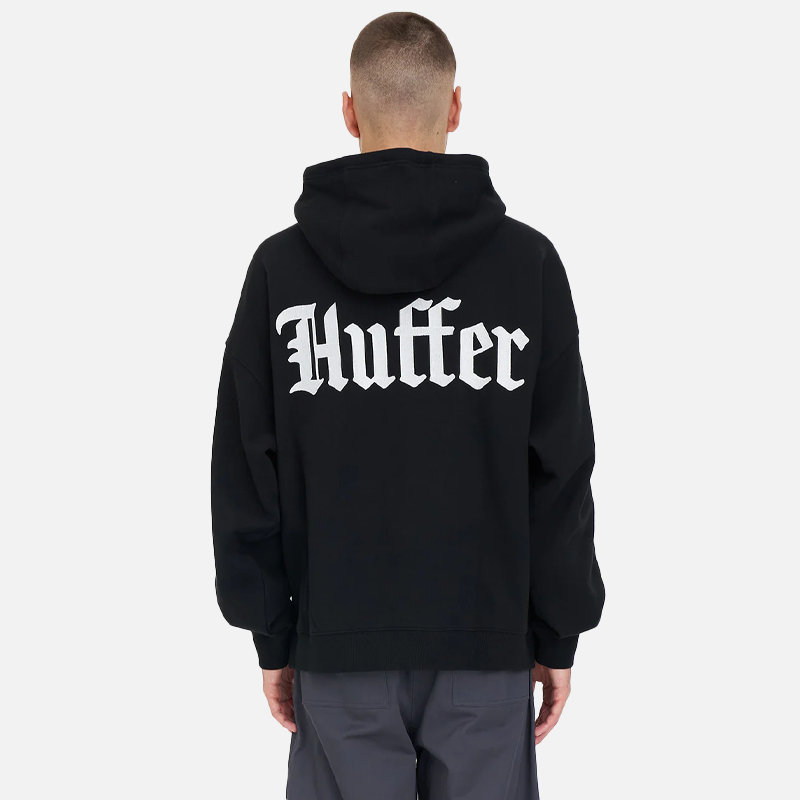 Person wearing a black hoodie with 'Huffer' branding on the back against a white background
